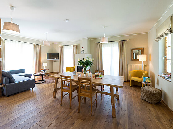 Wohnbereich mit Esstisch und Couch in der Suite Wildrose im Landhaus vom Hotel das Eisenberg (c) Jean Van Luelik Photographer.